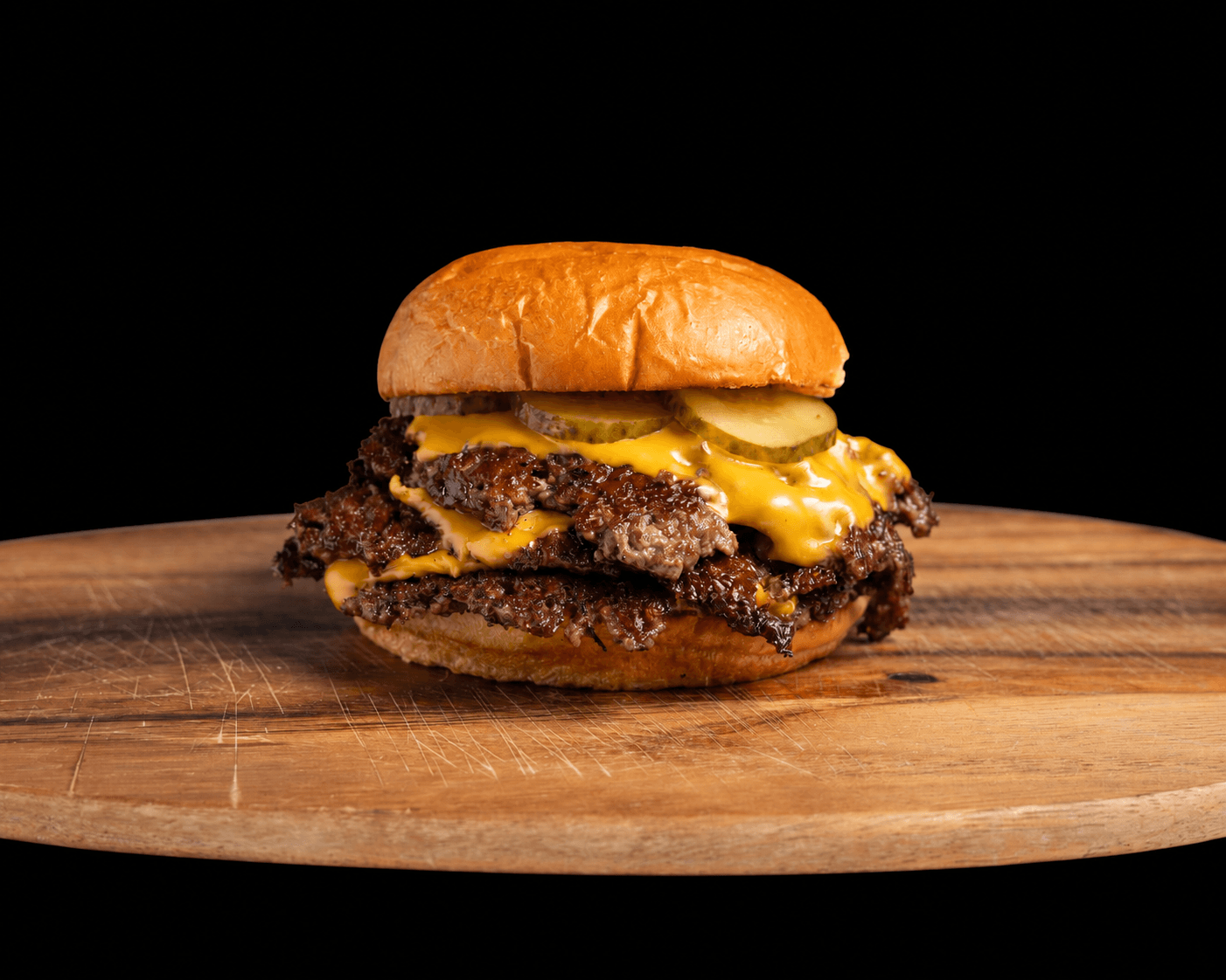 Proper Burger triple smashburger stacked with cheese.